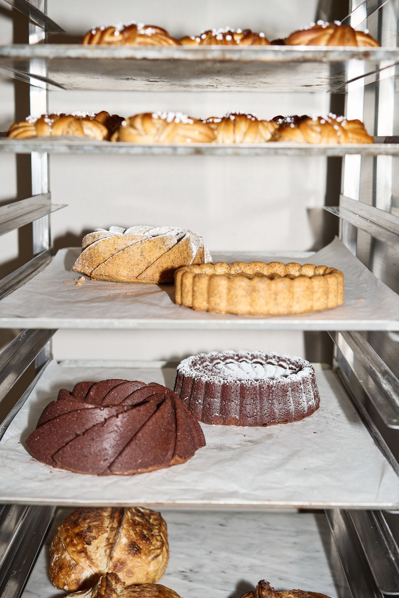 Here you can see a rack of baking trays with a selection of Lilian's baked goods, ranging from different types of bread and cakes to her famous Swedish cinnamon buns.